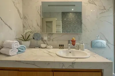 a bathroom with a sink and a mirror at Harmony House in Kissamos