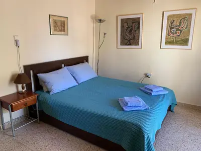 a bedroom with a bed with two towels on it at Cozy one-bedroom apartment in Halepa, Chania in Chania Town