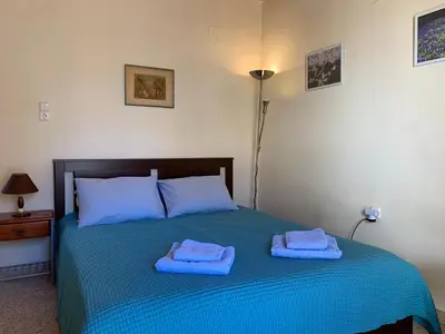 a bedroom with a bed with blue towels on it at Cozy one-bedroom apartment in Halepa, Chania in Chania Town