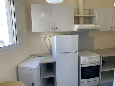 a kitchen with a white refrigerator and a dishwasher at Cozy one-bedroom apartment in Halepa, Chania in Chania Town