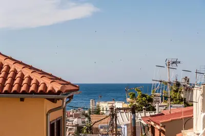 a view of the ocean from the roofs of buildings at Casa Emily in Chania Town