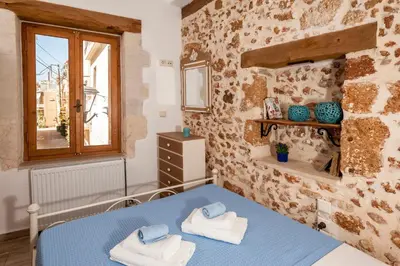 a bedroom with a blue bed and a window at Casa Emily in Chania Town