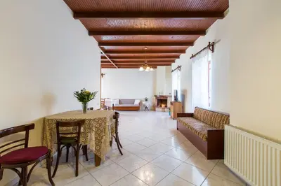 a living room with a table and a couch at Femina in Pírgos Psilonérou