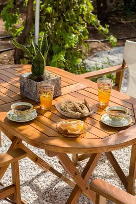 a wooden table with plates of food and drinks on it at Femina in Pírgos Psilonérou