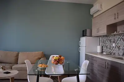 a kitchen with a table with a bowl of fruit on it at Sofia's view Kissamos in Kissamos
