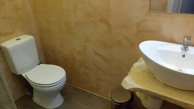 a bathroom with a white toilet and a sink at Sofia's view Kissamos in Kissamos