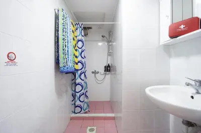 a bathroom with a shower and a sink at Steps From The Beach Aprt in Chania Town