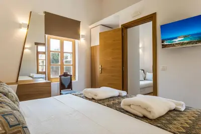 a bedroom with two white towels on a bed at Aelios Design Hotel in Chania Town