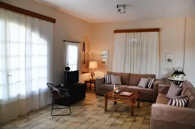 a living room with a couch and a table at Villa Avly in Maleme