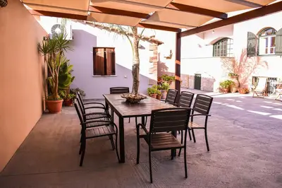 a wooden table and chairs on a patio at Villa Avly in Maleme