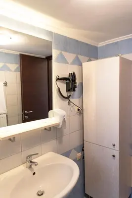 a bathroom with a sink and a mirror at Plumi City Apartments in Chania Town