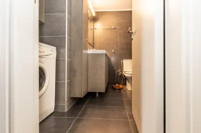 a small bathroom with a washing machine and a washer at Evridiki's House Central Chania in Chania Town