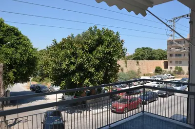 a balcony with a view of a parking lot at Evridiki's House Central Chania in Chania Town