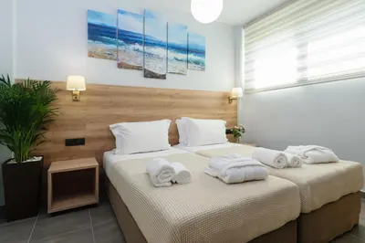 a bedroom with two beds with towels on them at Villa Thalia in Stalos