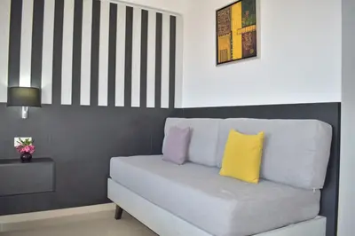 a living room with a couch with a yellow pillow at Galini Sea View in Agia Marina Nea Kydonias