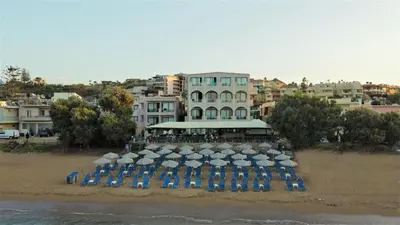 a group of umbrellas and chairs on a beach at Galini Sea View in Agia Marina Nea Kydonias