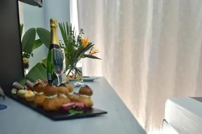 a table with a plate of food and a bottle of wine at Galini Sea View in Agia Marina Nea Kydonias