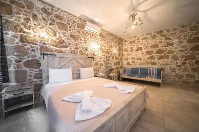a bedroom with a bed with towels on it at Nemesis in Plátanos