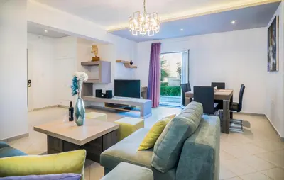 a living room with a couch and a table at Talos Luxury Suites in Kounoupidhianá