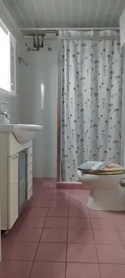 a bathroom with a shower with a toilet and a sink at Steps to Nea Chora beach Angela apt ,10min to town in Chania Town