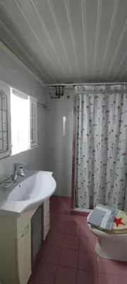 a bathroom with a sink and a shower curtain at Steps to Nea Chora beach Angela apt ,10min to town in Chania Town