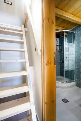 a staircase leading to a bathroom with a shower at Kyriaki's Traditional Loft in Galatás