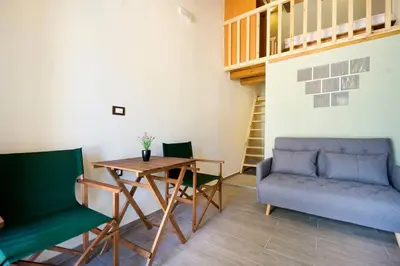 a room with two chairs and a table and a couch at Kyriaki's Traditional Loft in Galatás