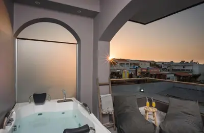 a bath tub sitting on top of a balcony at Sun Ray Luxury Apartments in Agia Marina Nea Kydonias