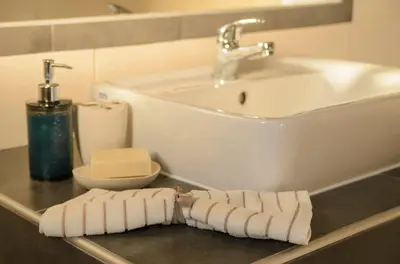 a bathroom with a sink and a towel on a counter at Madares Apartments Anopolis in Anopoli Sfakion