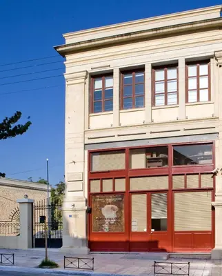 a building with a red and white facade at Apollon Hotel in Chania Town