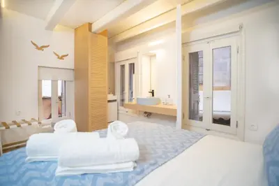 a large bedroom with two beds and a bathroom at Nine in Chania Town
