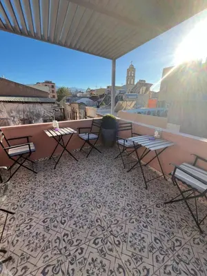 a patio with tables and chairs on a balcony at Nine in Chania Town