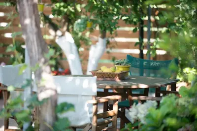 a wooden table with a basket of fruit on it at Christiana Apartments in Gerani Chanion
