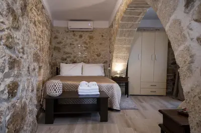 a bedroom with a bed and two shoes on a table at Μylos in Kissamos