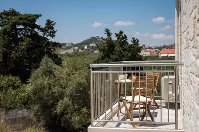 a balcony with a table and chairs in a cage at Villa Rebecca in Agia Marina Nea Kydonias