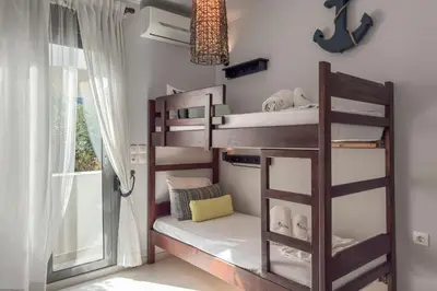 a bunk bed in a room with a window at Alisahni Villa & Suite in Kato Daratso