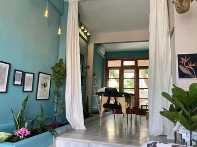 a living room with a grand piano in a room at Tree of Life Art Hotel in Agia Marina Nea Kydonias
