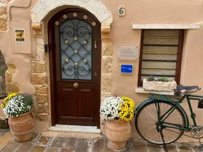 a bike parked in front of a house with a door at Calle Veneziana in Chania Town