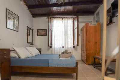a small bedroom with a bed and a window at Calle Veneziana in Chania Town