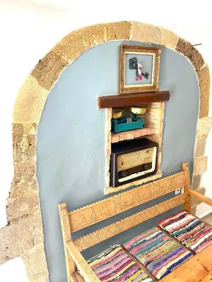 a wall with a fireplace with a picture on it at Calle Veneziana in Chania Town