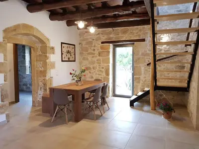 a dining room with a wooden table and chairs at Traditional Villa in fres in Frés