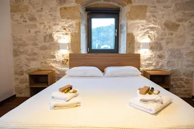 a bedroom with a bed with towels and a window at Traditional Villa in fres in Frés