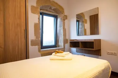 a bedroom with a bed and a window and a mirror at Traditional Villa in fres in Frés