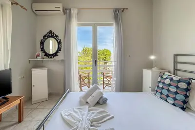 a bedroom with a bed and a large window at Alisahni Home 1 in Kato Daratso