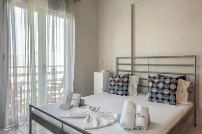 a bedroom with a large bed with white sheets and pillows at Alisahni Home 1 in Kato Daratso