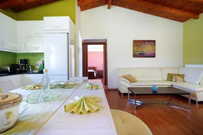 a living room with a white couch and a table at Penthouse in Chania Town