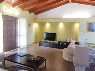 a living room with a couch and a tv at Penthouse in Chania Town