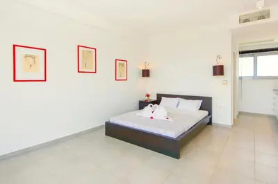 a bedroom with a bed with two stuffed animals on it at Luxury Villa Stella with private swimming pool in Tersanas