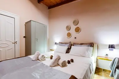 a bedroom with a bed with towels on it at Anna's Village House in Perivólia