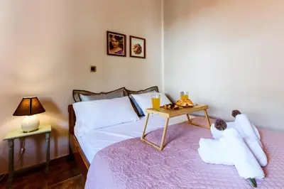a bedroom with a bed with a table on it at Anna's Village House in Perivólia